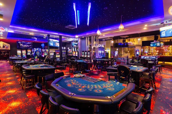 A glamorous woman holding casino chips in a neon-lit environment, representing the premium online casino atmosphere of FONBED.